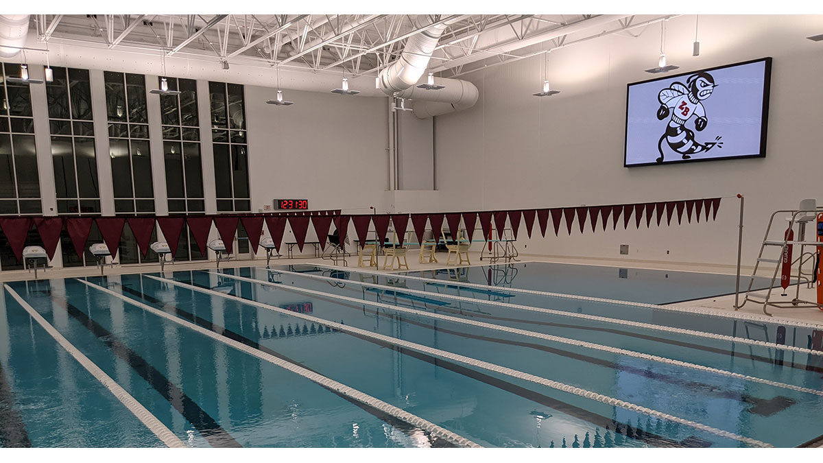 An indoor led video scoreboard at zion-benton high school's natatorium